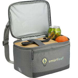 Rectangular soft-sided branded lunch box in gray, filled with a drink, fruit, and other food.